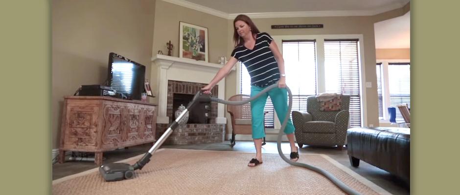 woman vacuuming an area rug